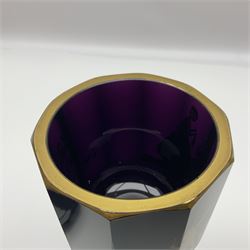 19th Century Bohemian amethyst glass lidded goblet, the bowl of faceted form, gilded with three children in period dress playing games, upon a knopped stem and conforming faceted foot, together with an art nouveau green glass goblet, with gilded rim, upon clear trumpet stem, and a hand blown wine glass, transfer printed with birds and three figures in period dress, tallest H29cm