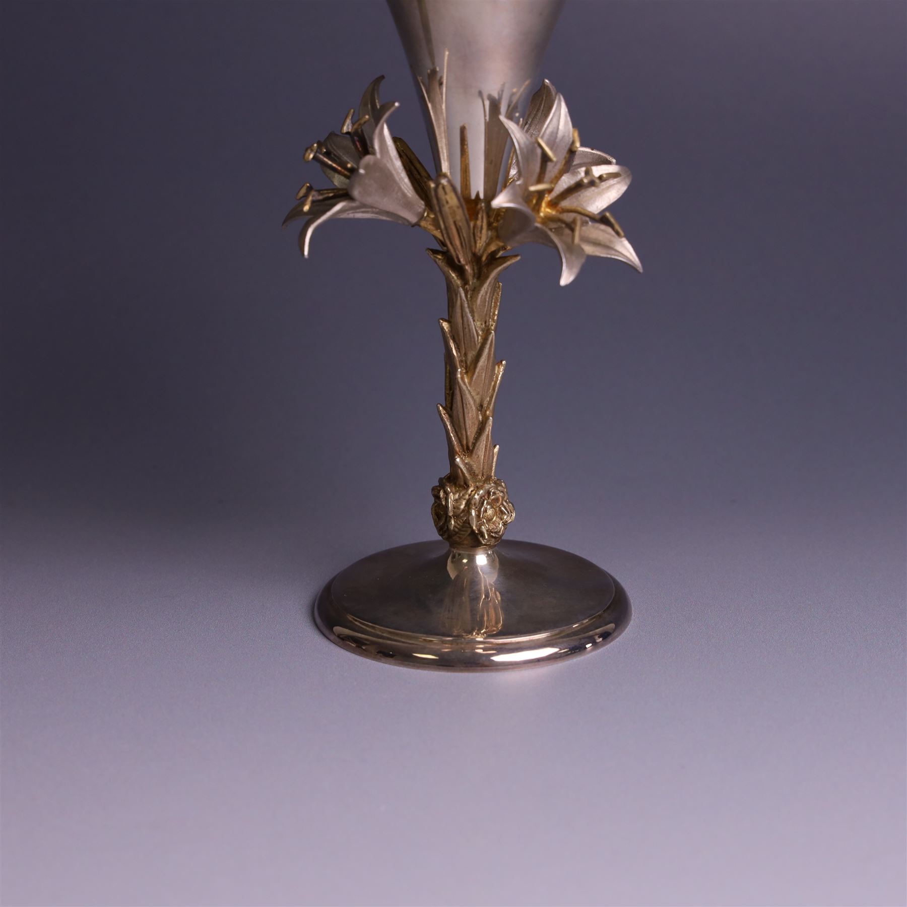 Modern limited edition silver goblet, 'made by order the provost and charter of Blackburn to commemorate the fiftieth anniversary of the cathedral in 1976 and its consecration in 1977' designed by Hector Miller for Aurum, the plain fluted cup, upon a stem of three lillies with parcel gilt highlihts and upon a circular foot, no. 2/750, hallmarked Hector Miller, London 1977, H17cm, boxed with certificate of authenticity