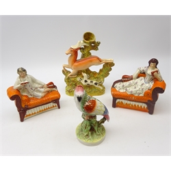  Staffordshire flatback figures of male and female musicians, lying on couches and reading music, L19cm, 19th century Staffordshire spill vase modelled as a Dog hunting Deer and 19th century Staffordshire parrot (4) Provenance: From a Private Yorkshire Collector  
