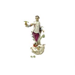 20th century Meissen figure, 'The Good Shepherd', modelled as a gentleman in 18th century dress with bird upon outstretched hand, stood against a tree with recumbent sheep at his feet, upon a scrolling base heightened with gilt, with underglaze blue crossed swords mark beneath, H26cm