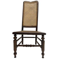 Early 19th century stained beech and mahogany child's correction chair, cane seat and back raised on turned supports united by stretchers