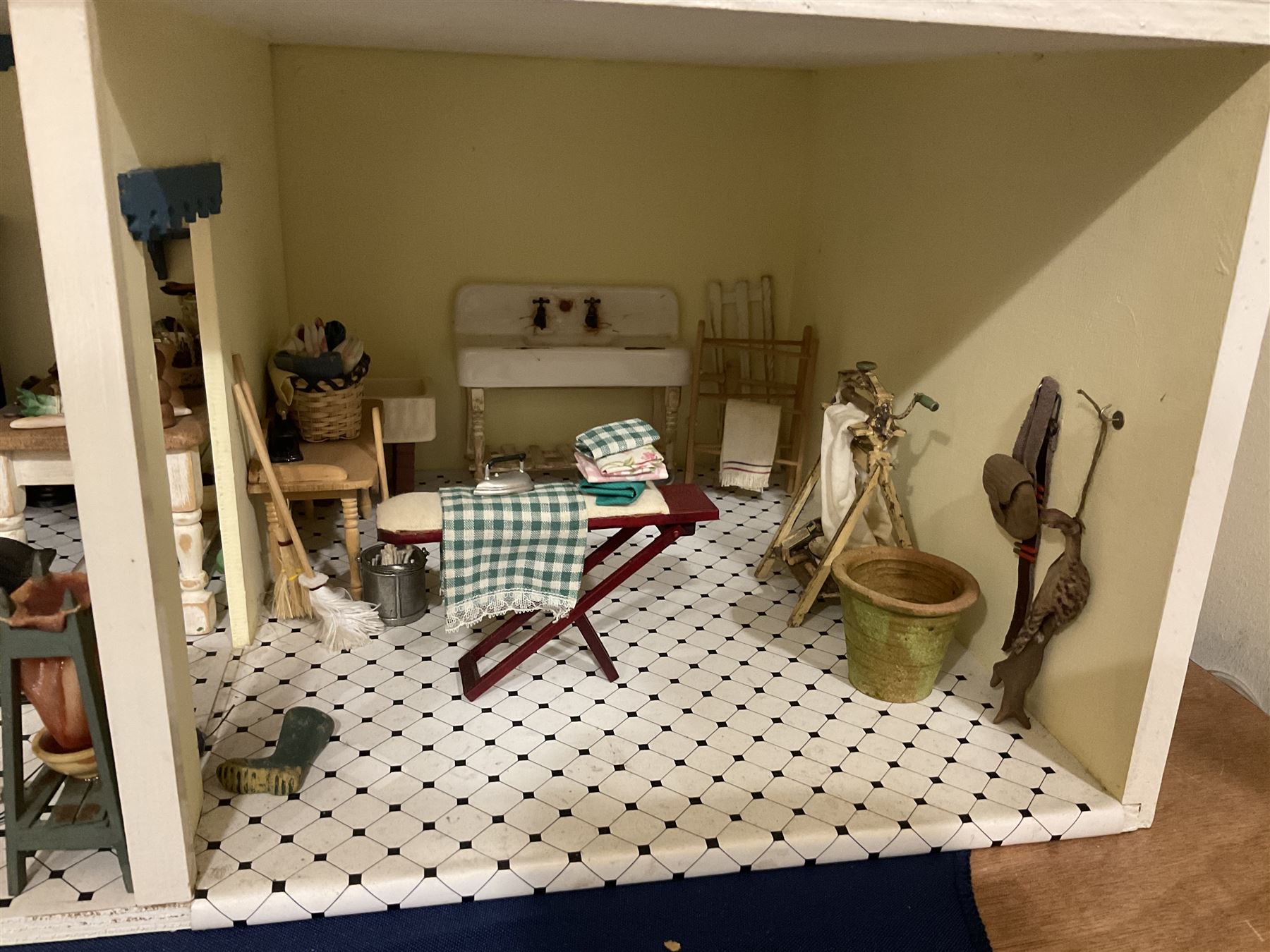 Honeychurch kit-built large wooden dolls house as a 19th century style double fronted four storey town house; with stucco finish under a pitched roof with Palladian style pediment and simulated tiles; protruding front courtyard with railings, street light and steps giving access to two fully furnished basement rooms; central door with Ionic columns and entablature; double hinged front facade opening to reveal a fully furnished interior with hall, stairs and landings and two rooms on each floor; wired for electric wiring W67cm H102cm D58cm