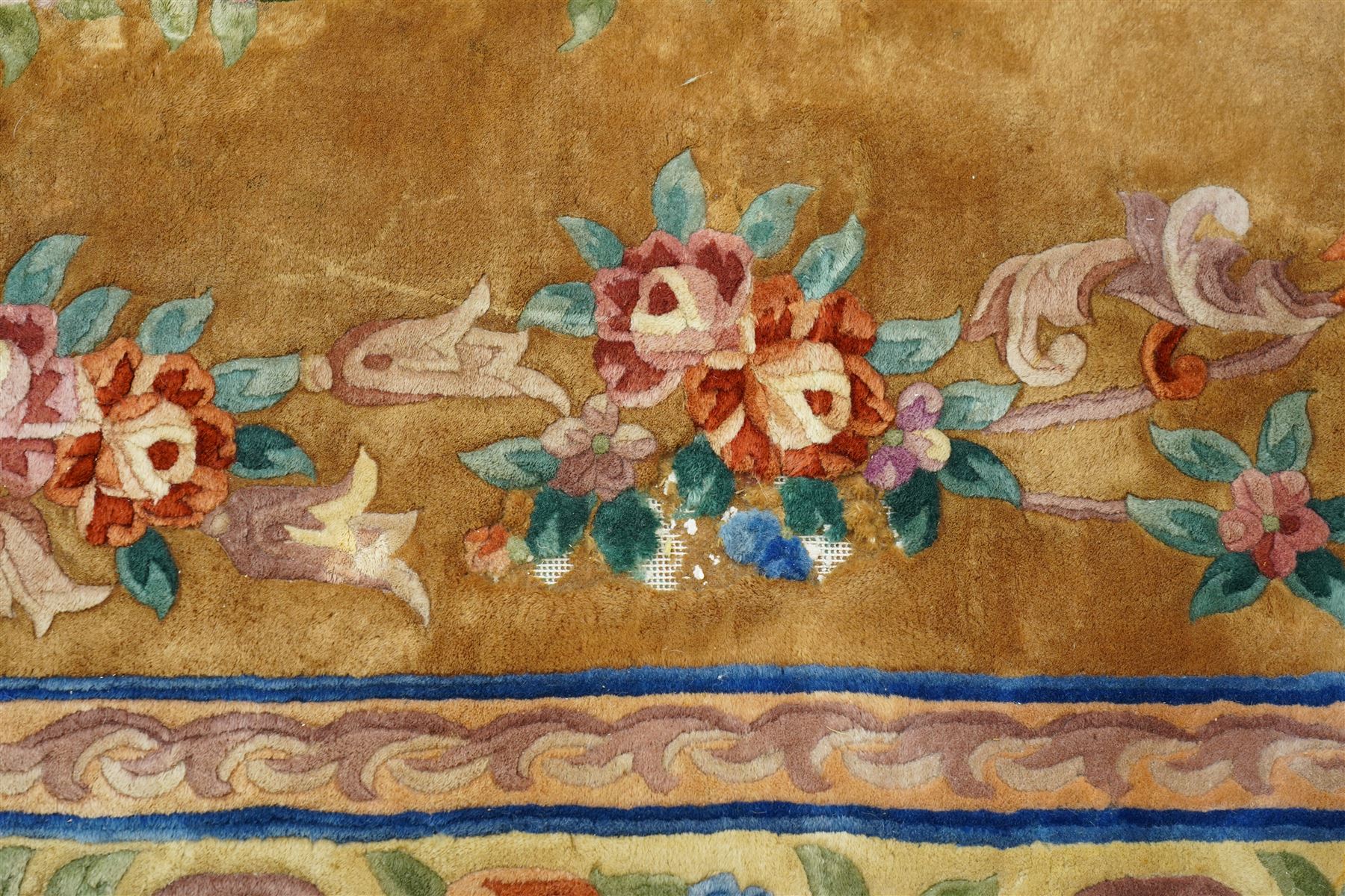 Chinese Aubusson/Savonnerie style hand-knotted carpet, ivory field with a central oval medallion issuing with stylized bouquets in shades of blush pink, pale blue, sage and green, enclosed by ribbon-tied floral garlands and conforming borders within narrow guard stripes, with cotton fringe ends 