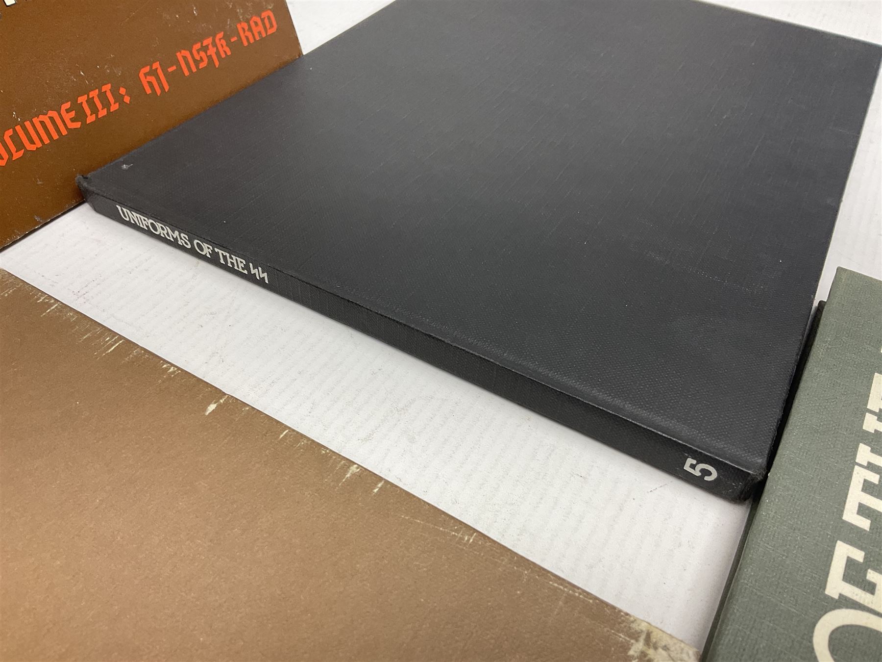 Military Collectors Service: set of three books on WWII German uniforms and badges; and Mollo Andrew: Uniforms of the SS. Volumes 1,4,5,6 & 7 (8)