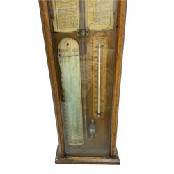 Admiral Fitzroy mercury barometer -  in a late 19th century fully glazed oak case c1870, with a round top and foliot carved arched crest, large bore bulb cistern tube, original charts annotated with Fitzroys remarks and observations,  twin vernier rack operated pointers, surface mounted mercury Fahrenheit thermometer and convex atmosphere/altitude chart.