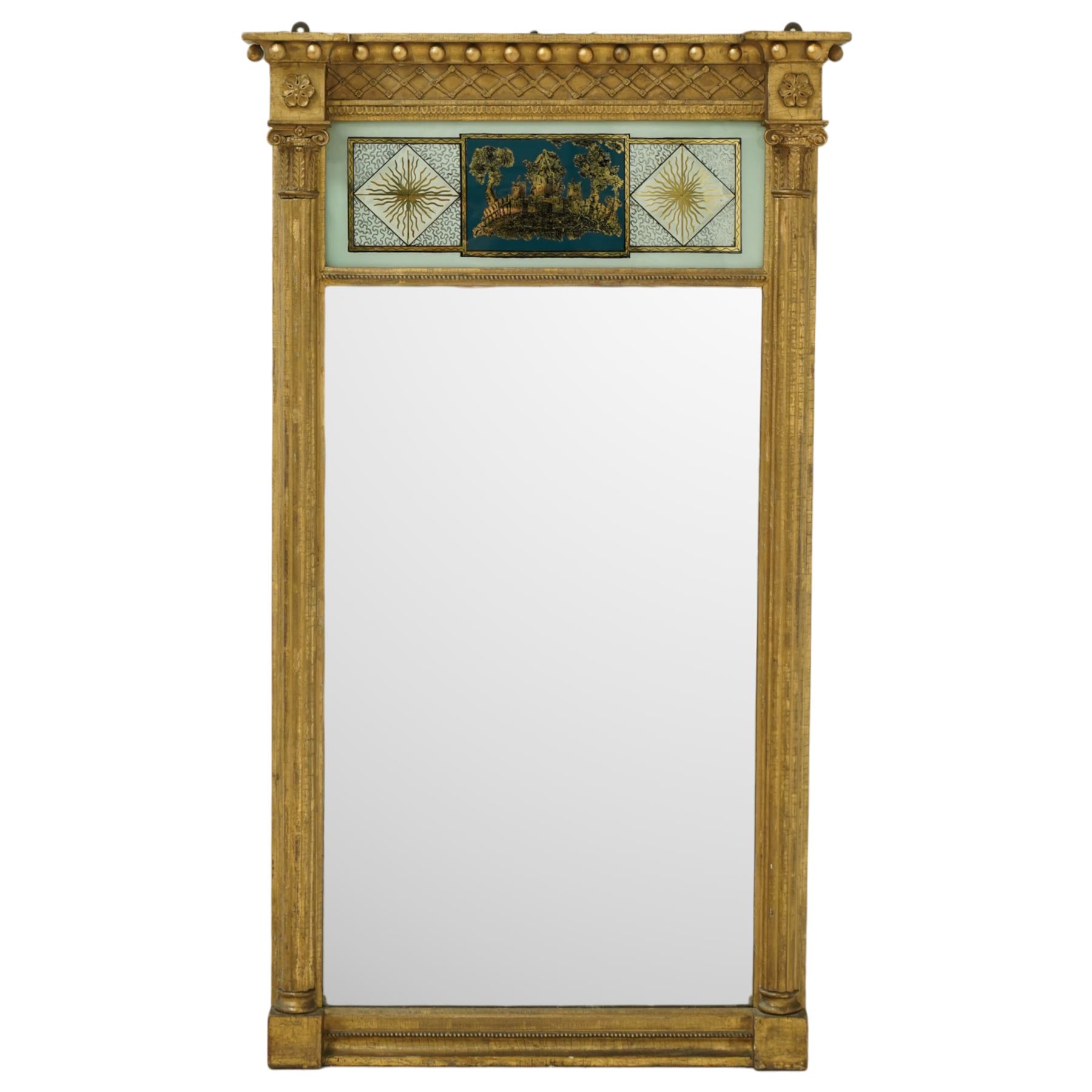 Regency period giltwood and verre-eglomise mirror, gilded frieze with trellis and ball design flanked by paterae and gilded beading beneath, above a large reverse painted glass panel depicting a monastic building between stylized diamond design with striations, gilded and hand-painted on glass flanked by Corinthian capitals above fluted columns between the original mirror plate above a stepped and beaded moulded base, circa 1815


Provenance: No. 1 Charlotte Square, New Town, Edinburgh.