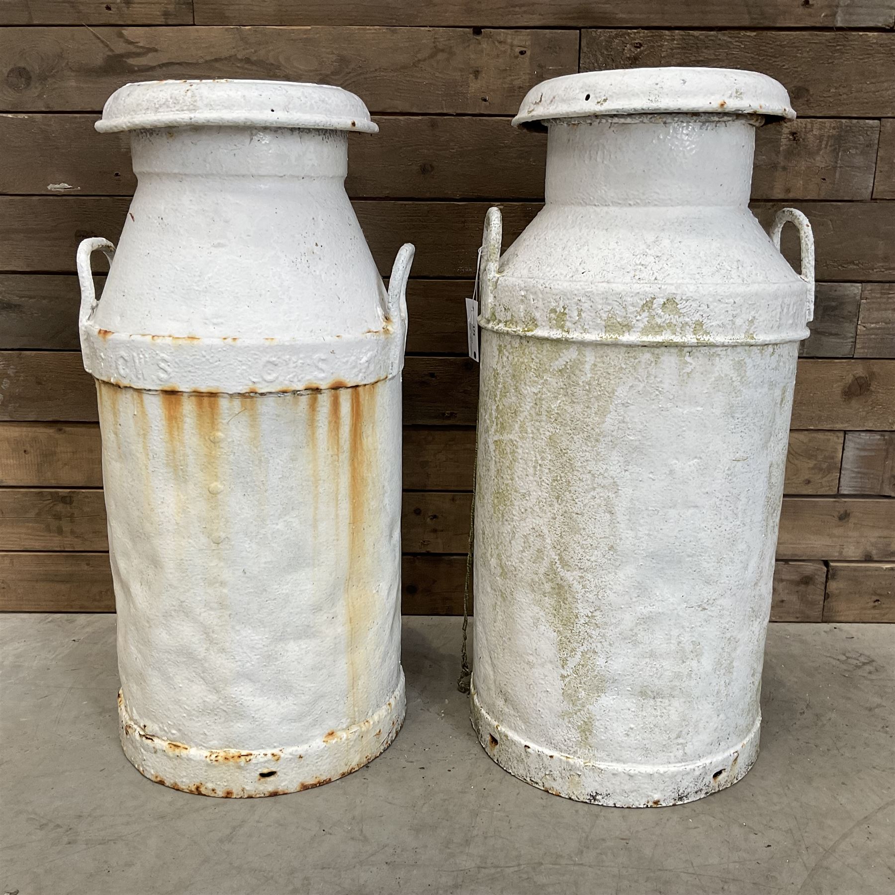 Two white painted milk churns with lids
