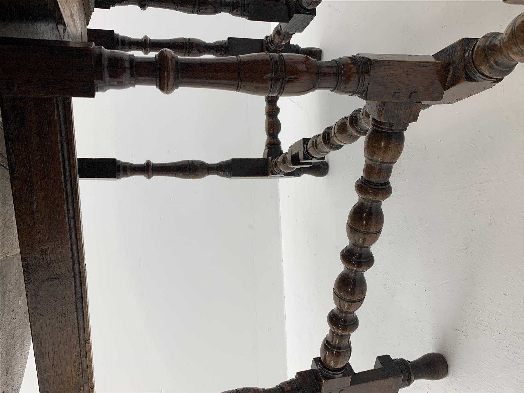 Late 17th century William & Mary oak drop leaf dining table, oval drop leaf top, single drawer to one end, gate action base, turned supports joined by bobbin turned stretchers, 121cm x 135cm, H75cm (open)