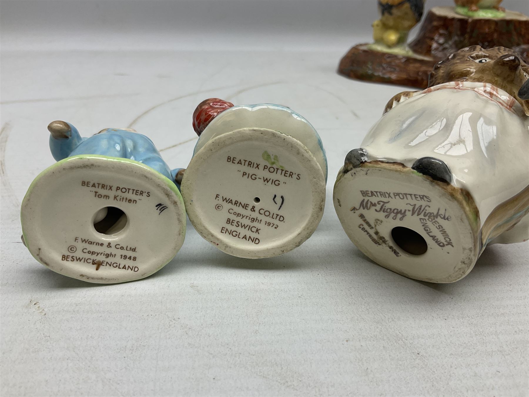 Seven Beswick Beatrix Potter figures, comprising Sally Henny Penny, Johnny Town-Mouse, Mrs Tiggy-Winkle, Mrs Tittlemouse, Tom Kitten, Pig-Wig and Squirrel Nutkin, together with a Beswick tree trunk display stand, stand L30cm