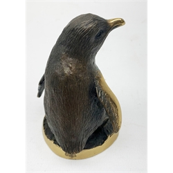 A cold painted model of a Kingfisher surmounted upon a branch surporting a small clear glass bowl, H10.5cm, together with a small bronze model of a penguin, stamped EWB, H7cm. 