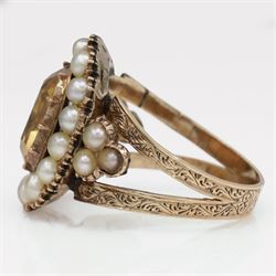 Georgian gold yellow topaz (possibly imperial) and split pearl cluster ring, collect set with a single oval cut foiled back topaz, surrounded by fifteen pearls and pearl set scroll engraved trefoil shoulders