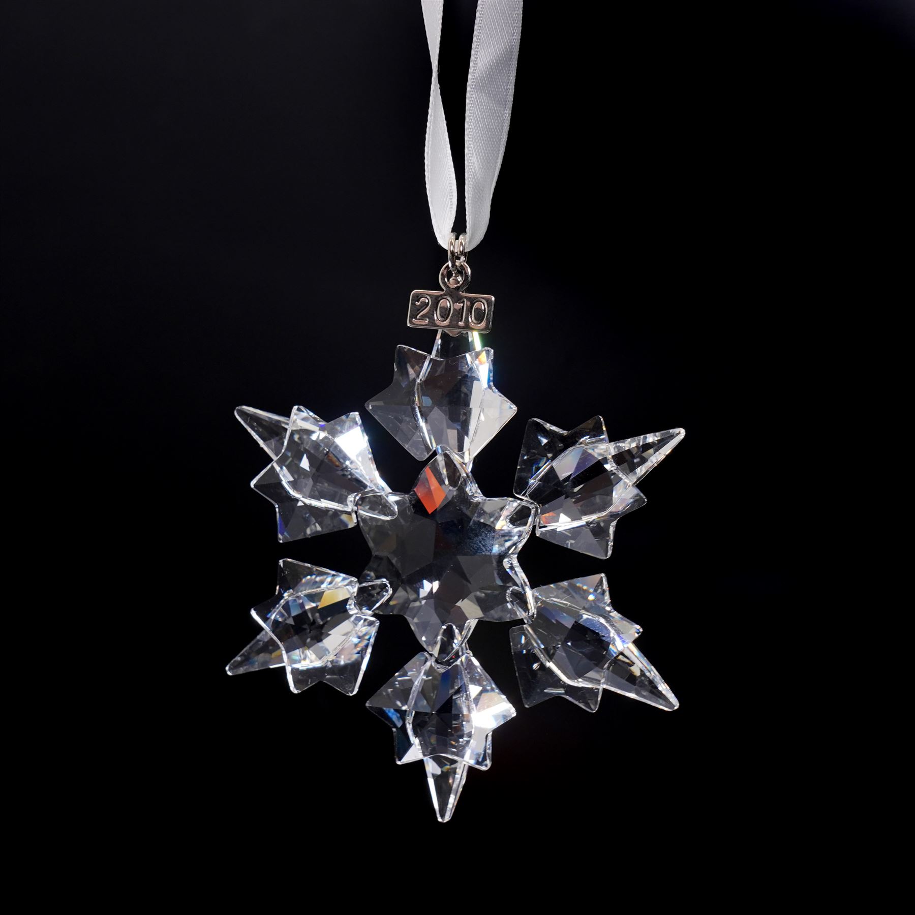 Nine Swarovski crystal snowflake Christmas ornaments, comprising years 1999-2005, 2010 and 2011, some with certificates, boxed (9)