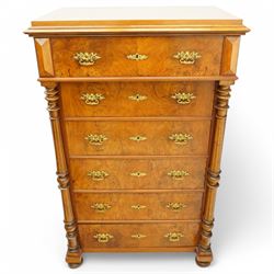 Tall late 19th century walnut chest, stepped and moulded top over six drawers, ornate cast gilt metal handles, enclosed by turned and fluted upright columns, on turned front feet 
