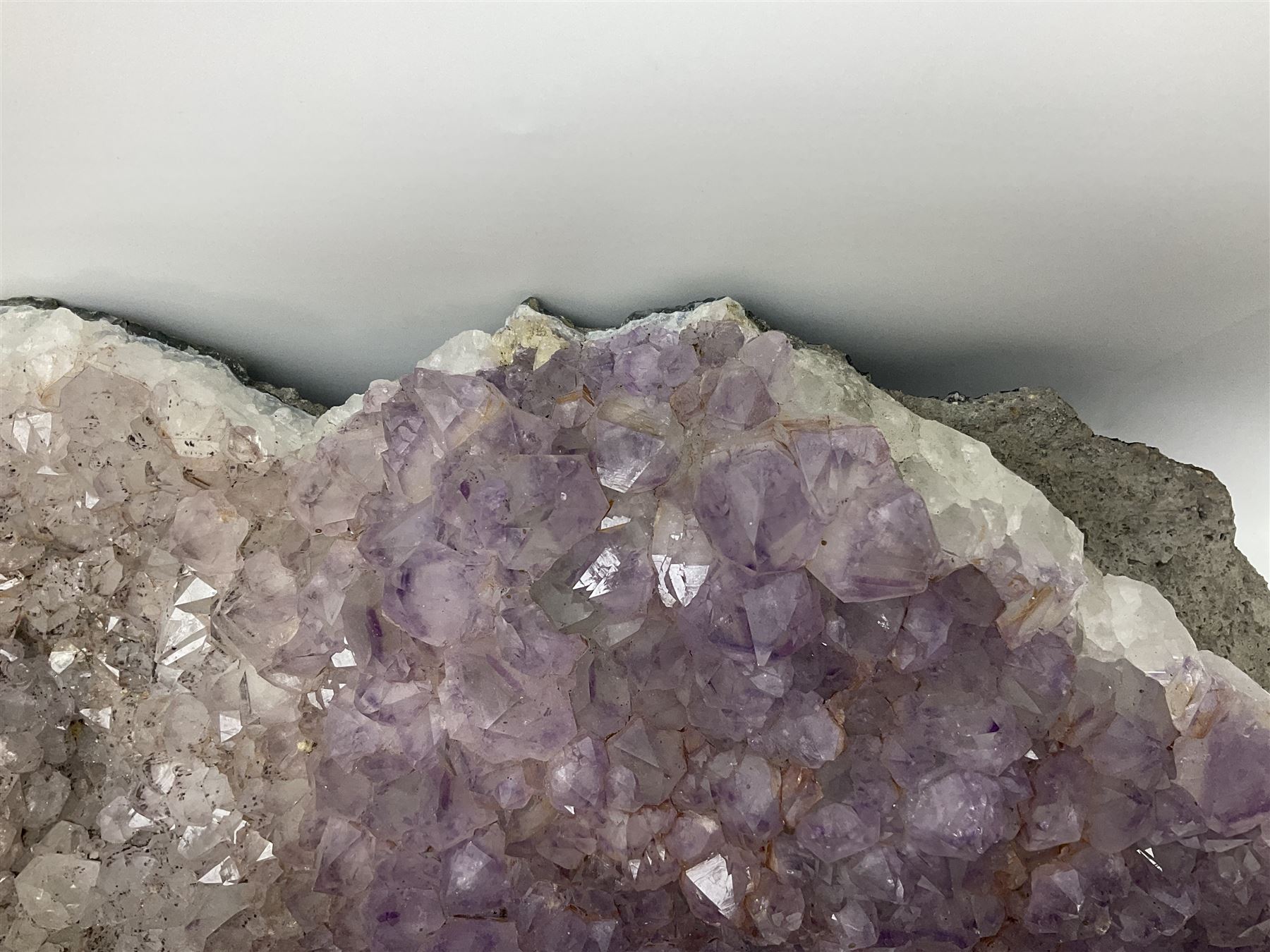 Amethyst crystal geode cluster, with well-defined crystals of various sizes, H13cm, L46cm