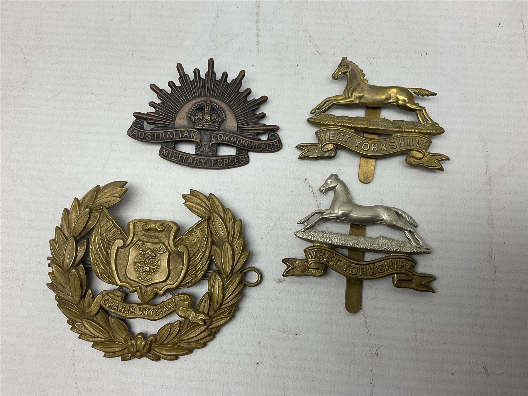 South African Army Orange Free State Artillery badge; three Commonwealth badges; and twelve Yorkshire/Lincolnshire badges including East Yorkshire, West Riding, York and Lancaster, West Yorkshire etc (16)