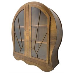 1930s Art Deco period walnut display cabinet, enclosed by two sun burst astragal glazed doors, on shaped plinth base
