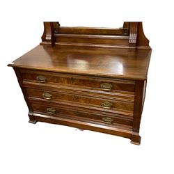 Late 19th/early 20th century walnut dressing chest with mirror back, the raised back with carved and figured pediment over swing mirror, the chest fitted with three long drawers