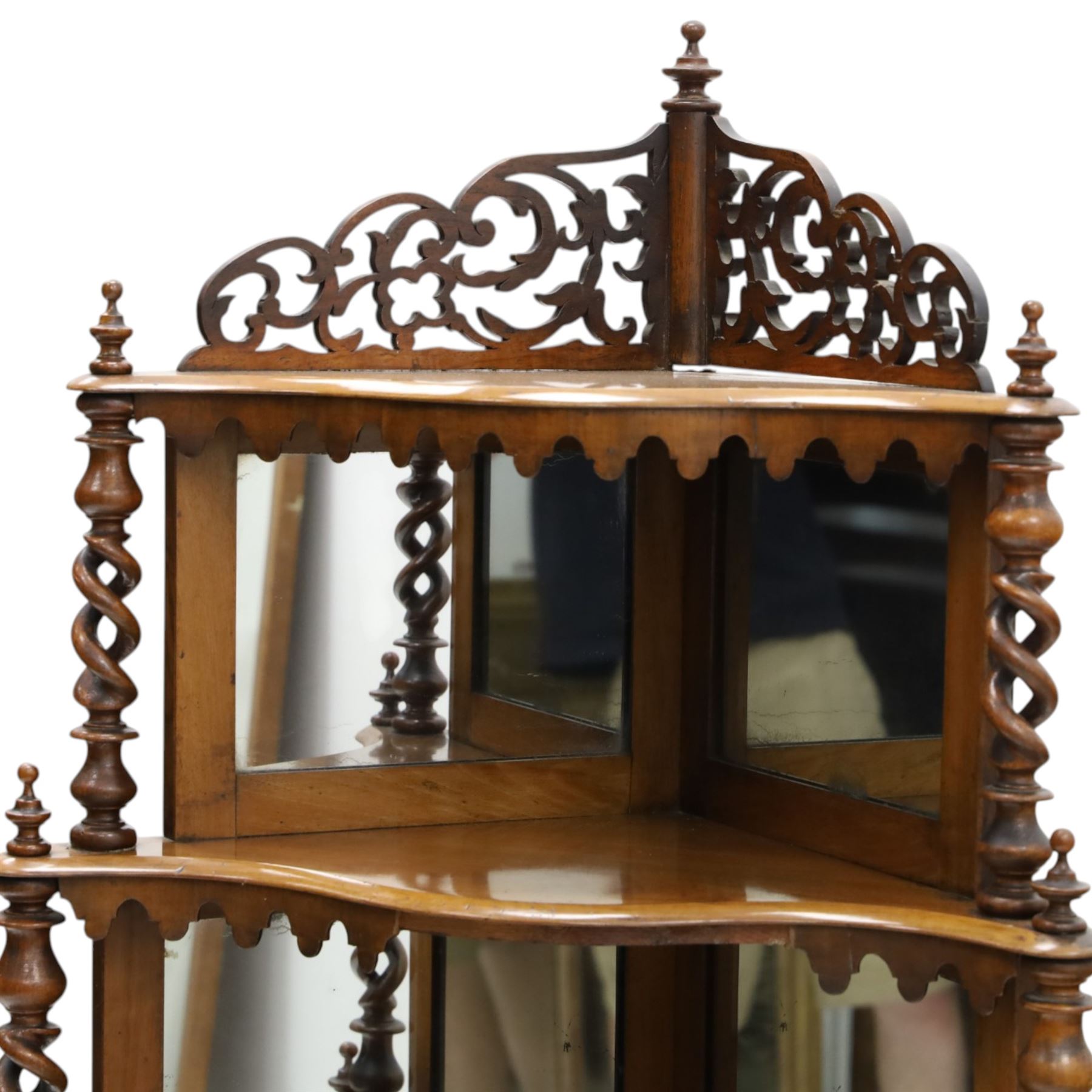 Victorian mahogany five-tier corner whatnot, raised and pierced back of scrolling foliate design, over two tiers with mirror backs and pear-drop moulded aprons, united by pierced spiral-turned uprights, on turned feet