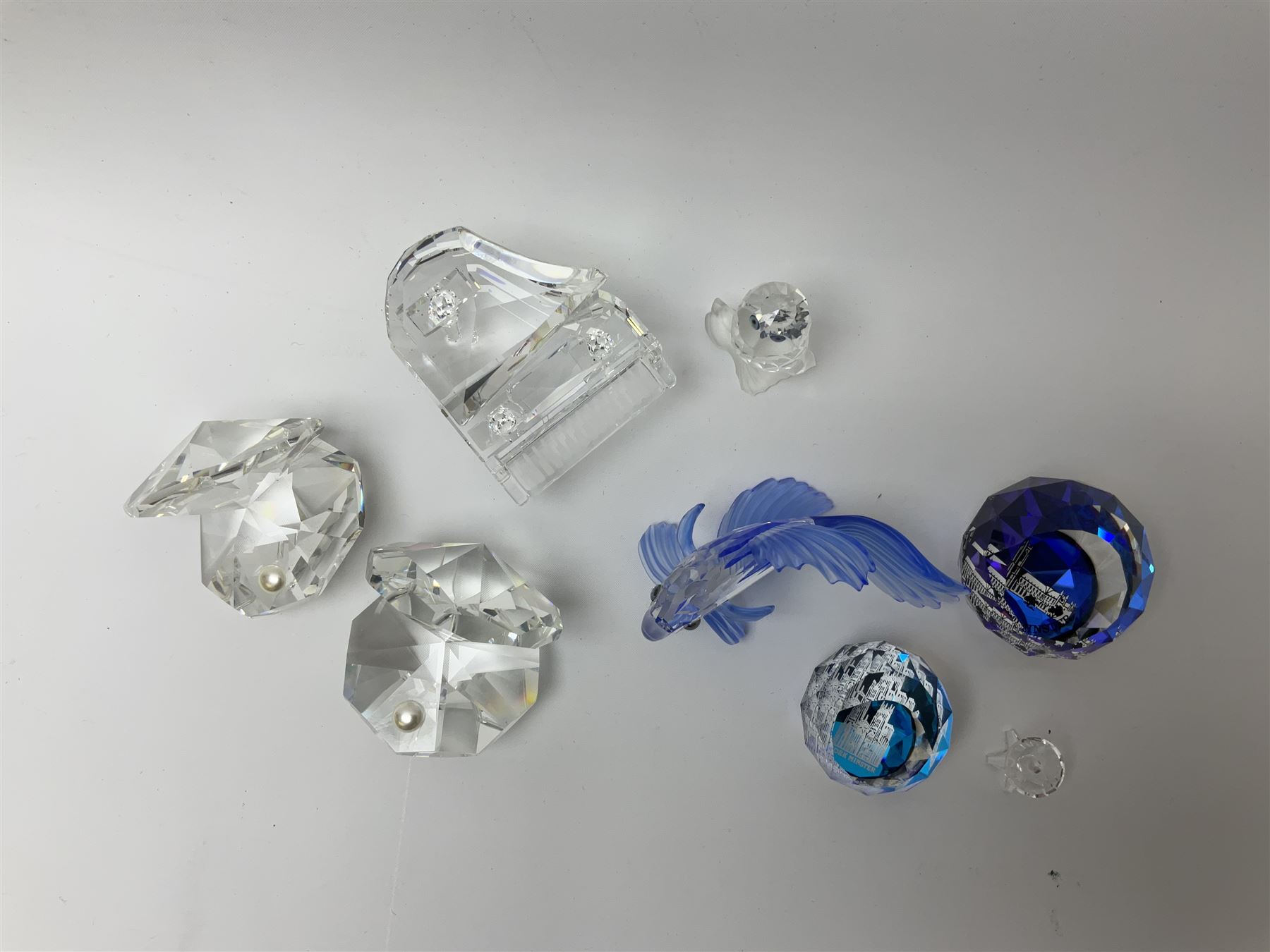 Six Swarovski crystal models, comprising an example modelled as a  Siamese fighting fish, two examples modelled as oyster shells with pearls, another modelled as a piano, plus a York Minster paperweight, Beverly Minster paperweight, and a Crystal Reflections model of an owl. 