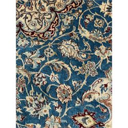Persian Nain blue and ivory ground rug, wool with silk inlay, overall arabesque design, central medallion surrounded by interlacing and scrolled leafy branches and palmettes, the scrolling border decorated with stylised plant motifs, within guard stripes