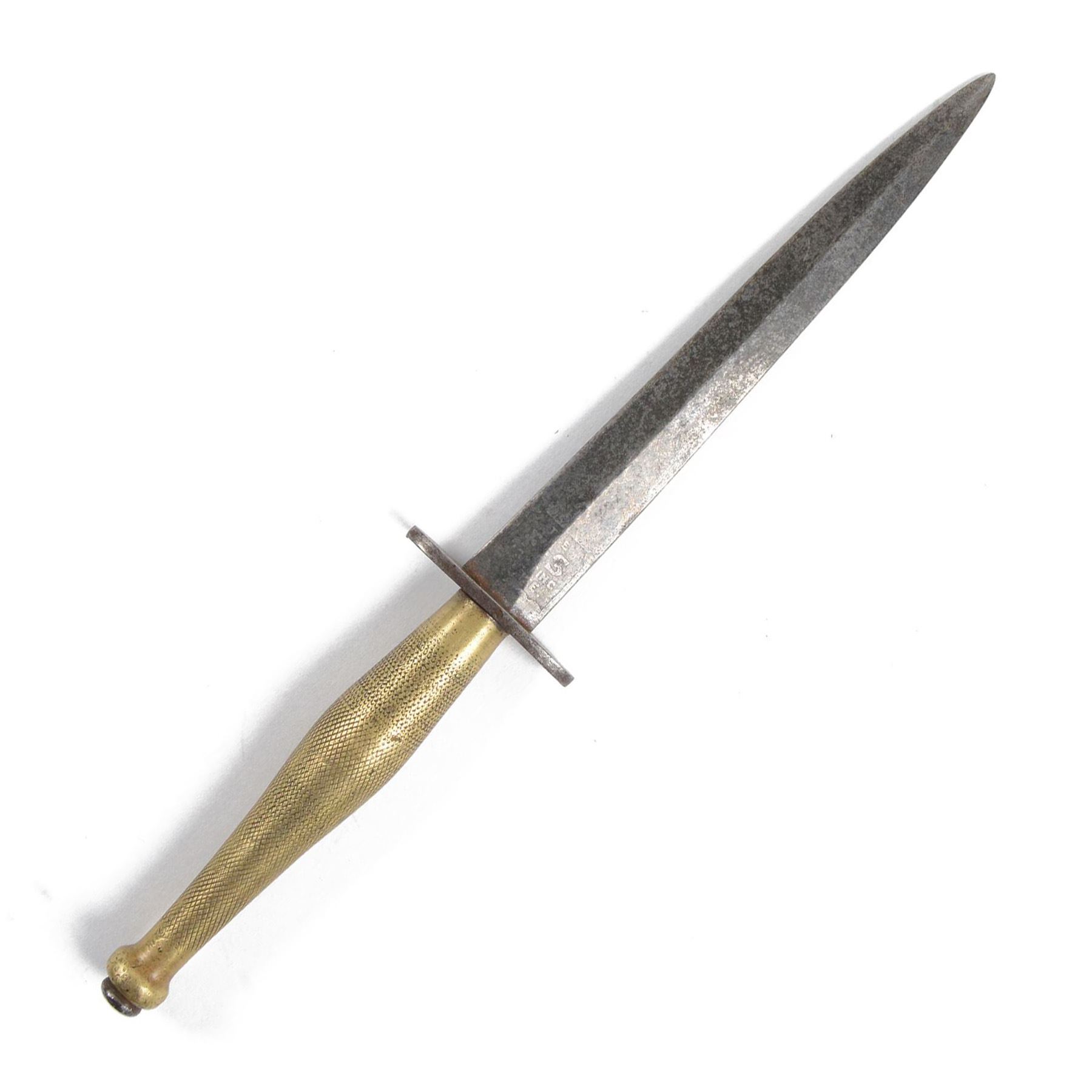 Fairbairn Sykes Fighting Knife, the 17cm double edged blade etched to the ricasso 'F-S Fighting Knife', brass checkered grip with steel ball pommel nut, overall L29cm