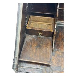 George III oak bureau, sloped fall-front enclosing a fitted interior with pigeonholes, small drawers, and a central compartment, over two short and two long drawers, brass escutcheons and drop handles, raised on bun feet