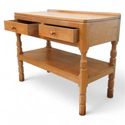Mouseman - oak side table or buffet, raised back over rectangular canted adzed top, fitted with two drawers, raised on four octagonal turned supports united by undertier, carved with mouse signature, by the workshop of Robert Thompson, Kilburn 