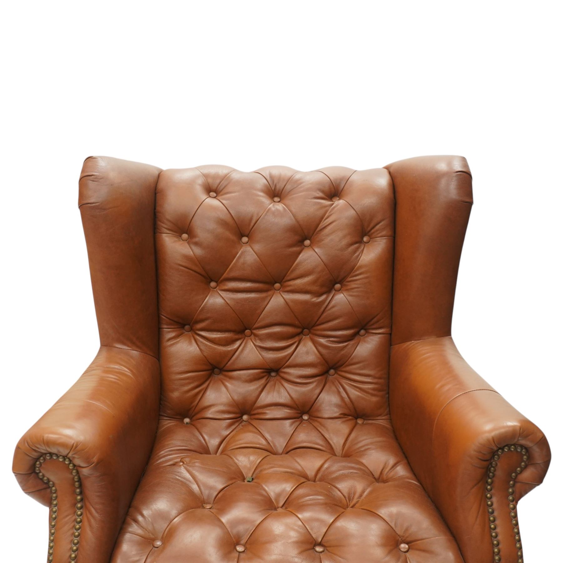 Alexander James design fully tan leather chair, with full button back seat and back, with scrolled arms with studded trim, raised on light stained turned supports