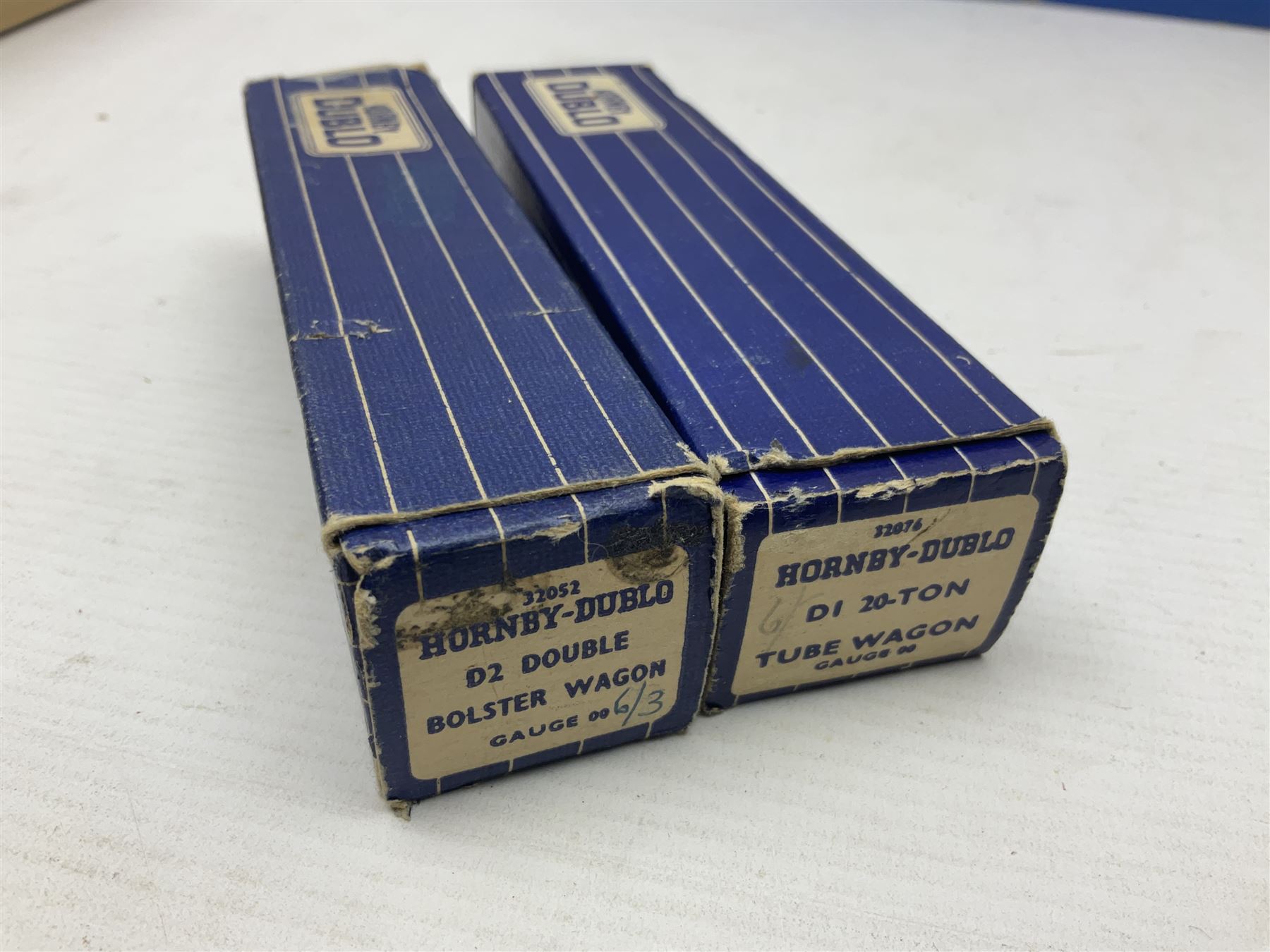 Hornby Dublo - nineteen goods wagons comprising 32040 Goods Van D1 (SR) in LMS stickered box, DR375 Goods Van D1 (GW), D303 Open Goods Wagon D1 (GW), 32044, 32076, 32052, 32021, 32074, 32056, 32065, DR379, 32070, 32020, DR373, two x 32075, High Sided Wagon D2 (LMS) in NE stickered box; all boxed; Tank Wagon D1 (Esso) and DR380 Meat Van D1; both in later unassociated boxes (19)