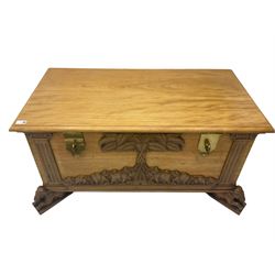 India camphor wood blanket box, moulded hinged lid, decorated with carved elephants and trees, on elephant carved feet