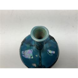 Minton Secessionist vase, with tube-lined stylised flower decoration, upon a blue ground, with printed mark to base 'Minton Ltd, No. 32', H13cm