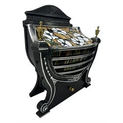 Stained glass and cast iron electric fireplace, arched top with decorative finials, stained glass front panel with floral motifs, flanked by cast iron scrolls, raised on scroll supports