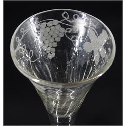 Two mid 18th century drinking glasses, the first example with part fluted drawn funnel bowl engraved with fruiting vines upon a plain stem and conical foot, H17cm, the second example with funnel bowl engraved with barley and hops upon a plain stem and folded circular foot, H15cm