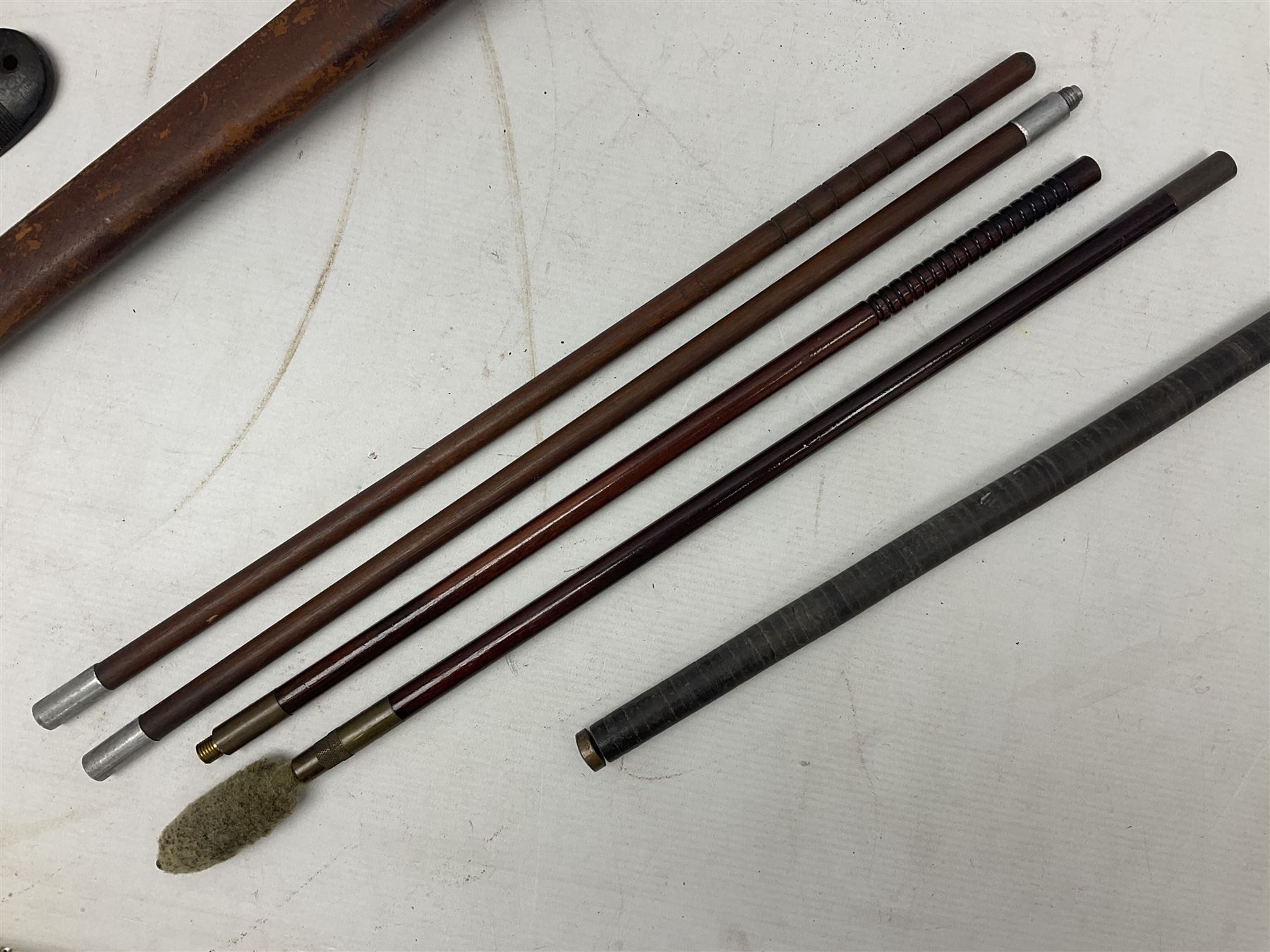 George V 1897 pattern Infantry officers sword, the 82cm single fullered blade with traces of etched detail and George V crown cipher, the ricasso marked Hawksworth Sheffield, pierced half basket hilt with George V cypher, wire-bound fish-skin grip with brass pommel and backstrap; in leather scabbard L102cm overall; together with two sectional gun cleaning rods; swagger stick made of leather strips etc