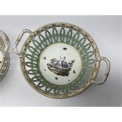 Pair of 19th century German openwork chestnut baskets, with twin handles and scrolling gilt border and star rim, painted to the centre with birds and insects, D22cm 