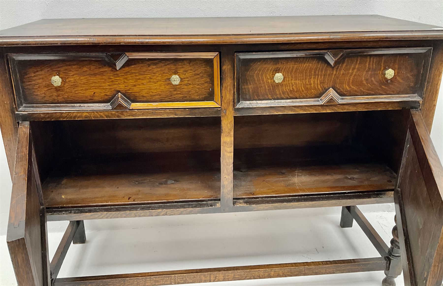  Jacobean style oak sideboard, two drawers above two cupboards, barley twist supports joined by stretchers 