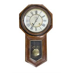 American - Late 19th century Ansonia 8-day wall clock, with a hexagonal wooden dial surround and circular spun bezel, glazed case door and visible pendulum,  two part dial with Roman numerals, minute track, spade hands and seconds dial, twin train spring driven movement striking the hours on a gong.