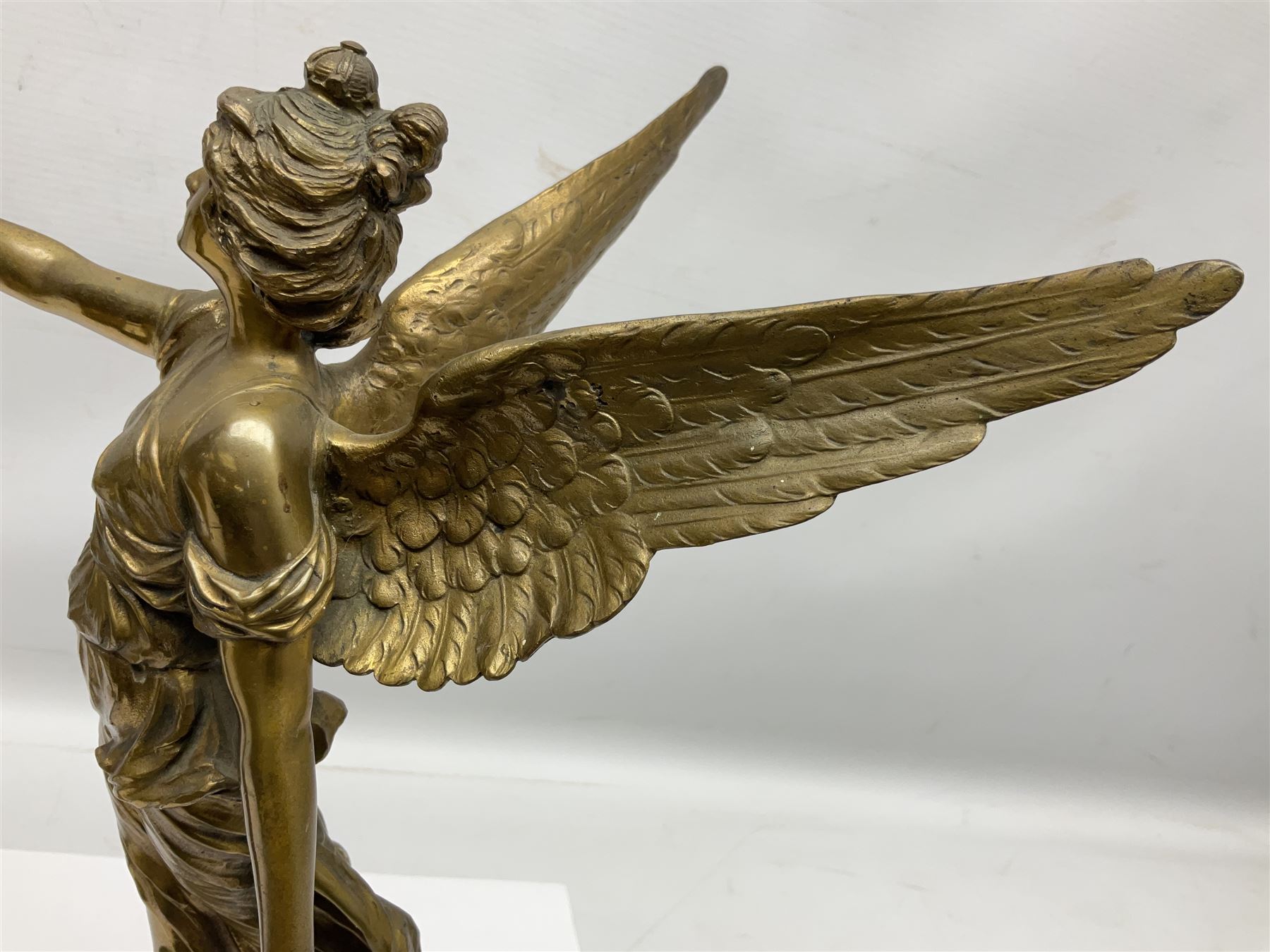 After Oswald Schimmelpfennig (German, 1872-1939): Pair of gilt bronze winged Allegorical female figures, the first example with arm outstretched holding a branch, signed 'Schimmelpfennig 1900', the second with arm raised above her head holding a book and sword in the other, both raised upon marble plinths, H45cm