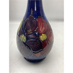 Moorcroft Clematis pattern upon a blue ground, ovoid vase with slender neck, impressed mark beneath, H28cm