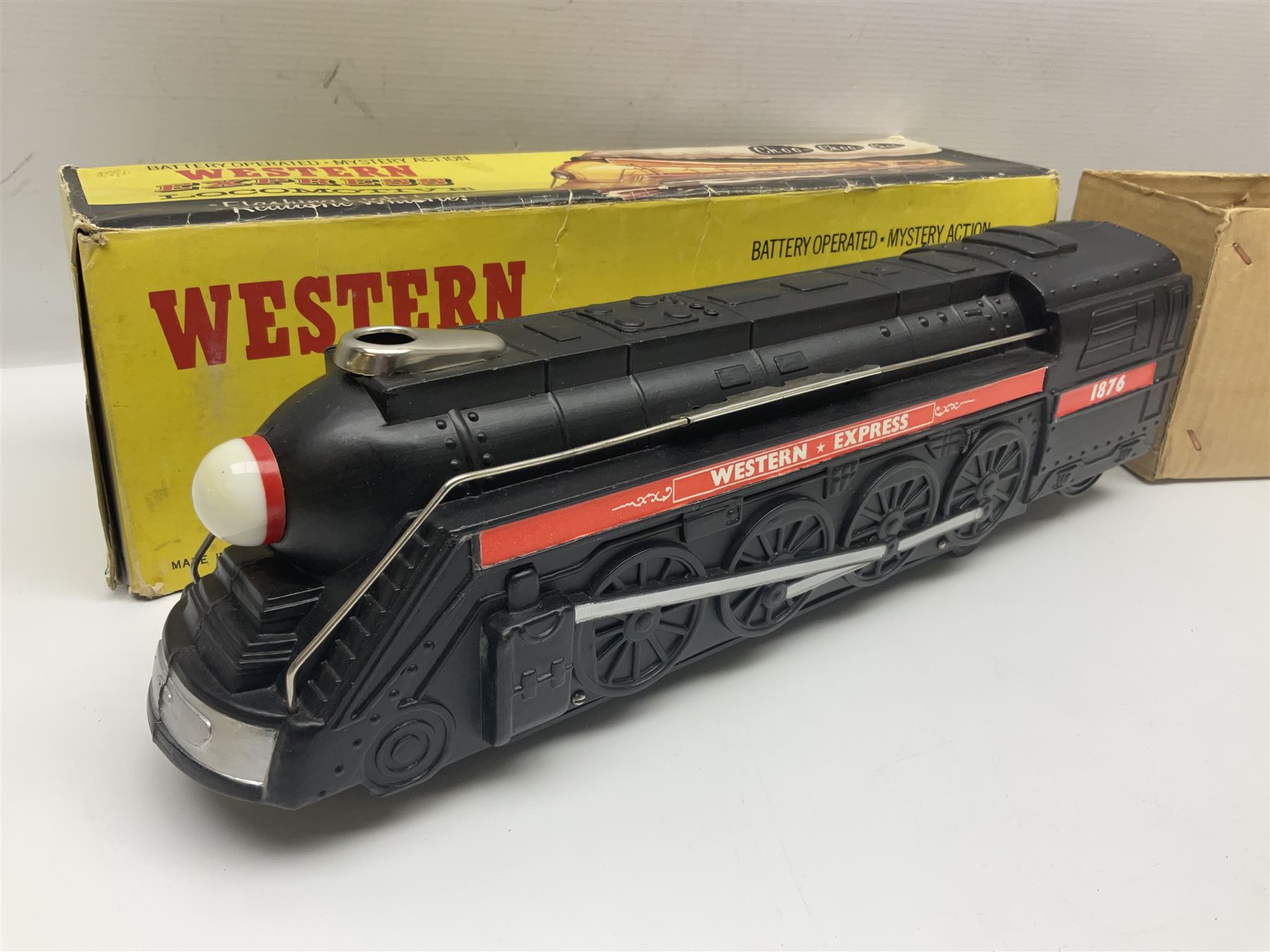 Mickey Mouse Trick Star battery operated drummer figure; Illco Mickey Mouse battery operated Fun Castle Roller Coaster; battery operated Western Express Locomotive; and JK Wells Fargo Overland Stage scale model; all boxed (4)