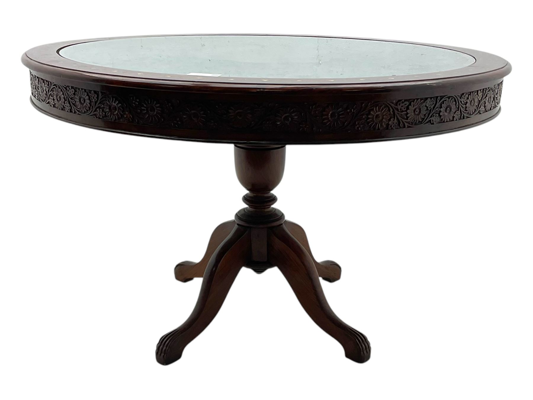 Pakistan carved hardwood brass inlaid circular dining table, and four rail back chairs with saddle seats