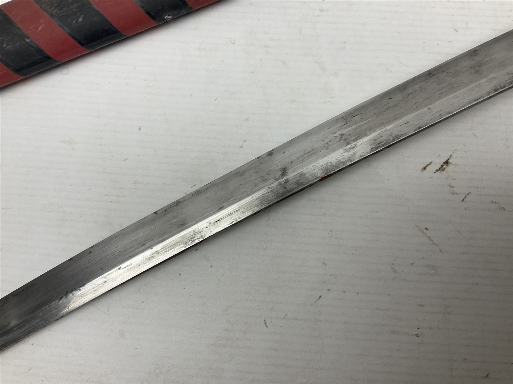 Good quality Japanese sword blade with later WWII fittings and scabbard  - 67.5cm slightly curving blade with unmarked tang, plain iron tsuba and lacquered grip with copper mounts; in lacquered wooden scabbard with tape bound tip L94cm overall