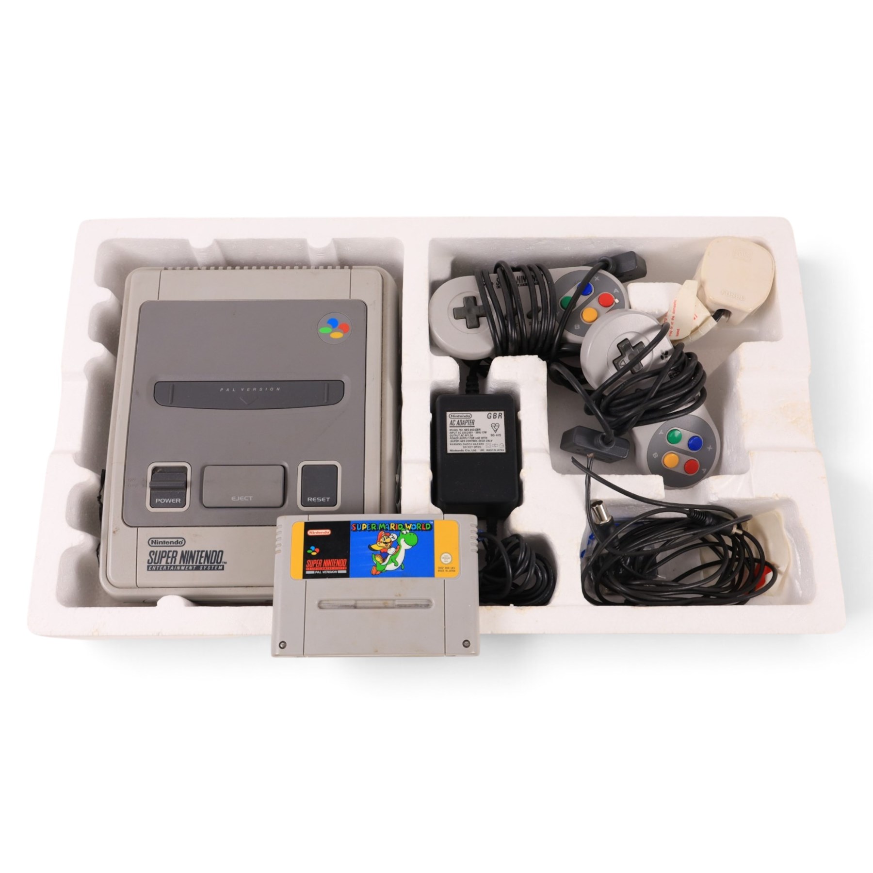 Super Nintendo Entertainment System Pal Version, comprising Super NES Control Deck, Super Mario World Game Pack, two controllers, aerial switch box and AC adapter, boxed