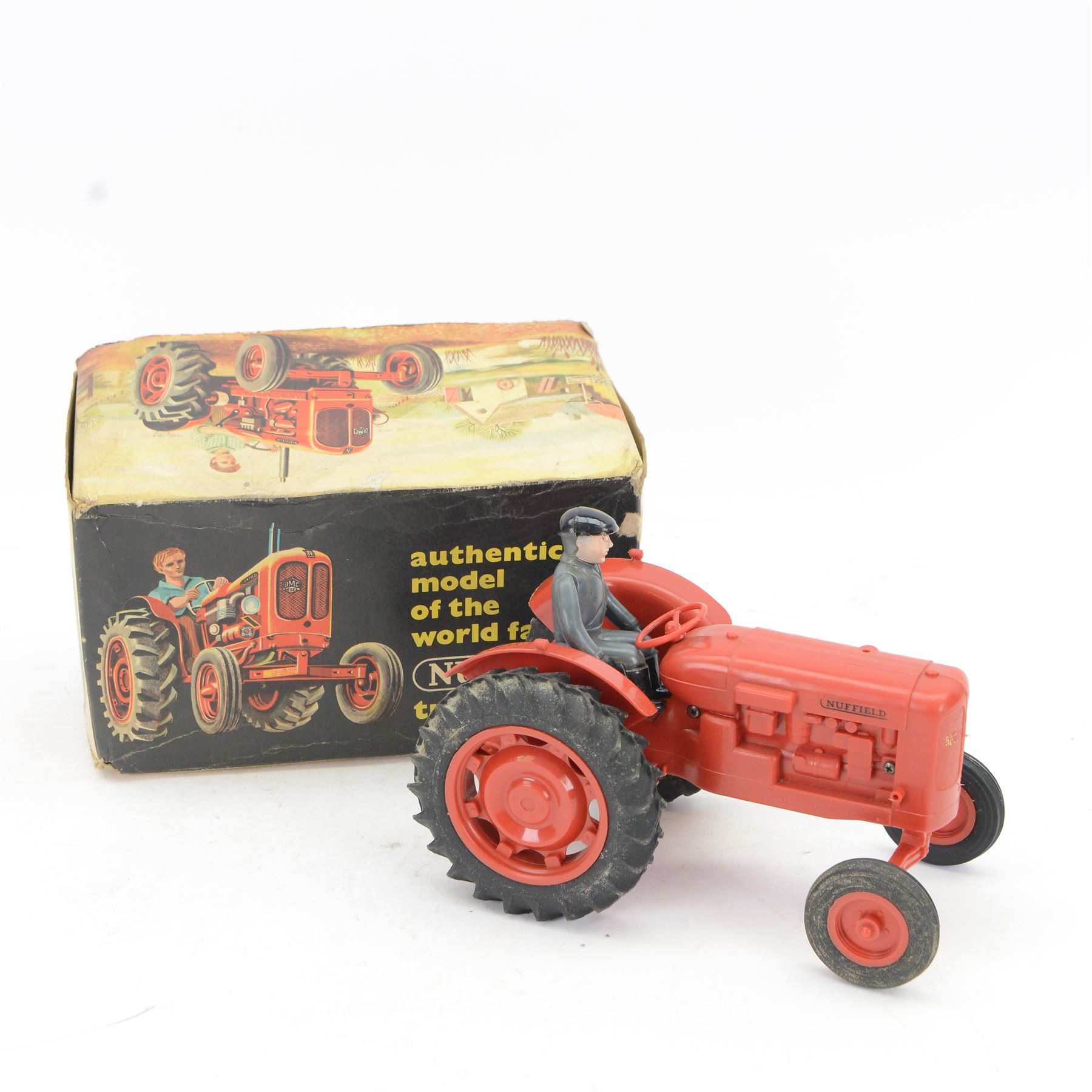 Pippin Toys Nuffield Tractor model, with red plastic body, rubber tyres and matched plastic farmer figure, in original box