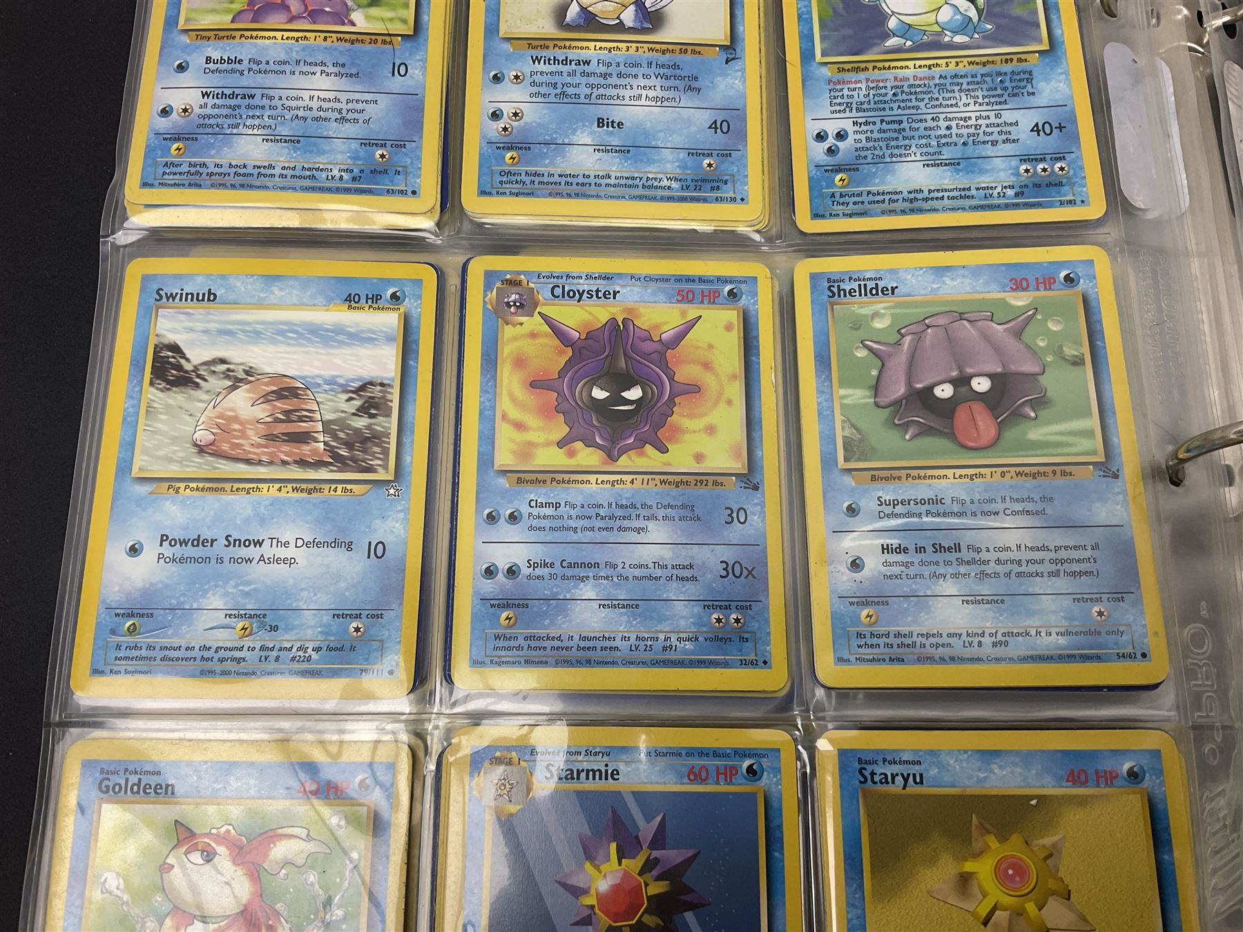 Collection of Pokemon trading cards, mostly 1999 Wizards Pokemon cards to include holo Charizard 4/102, first edition holo Machamp 8/102, further holographic cards; Dark Flareon 35/82 and Dark Vaporeon 45/82, cards from themed sets and 4th edition prints; 1998 Electronic Pokédex with cardboard boxes for themed decks Blackout, Overgrowth and Power Reserve Jungle, along with a large quantity of energy and trainer cards 