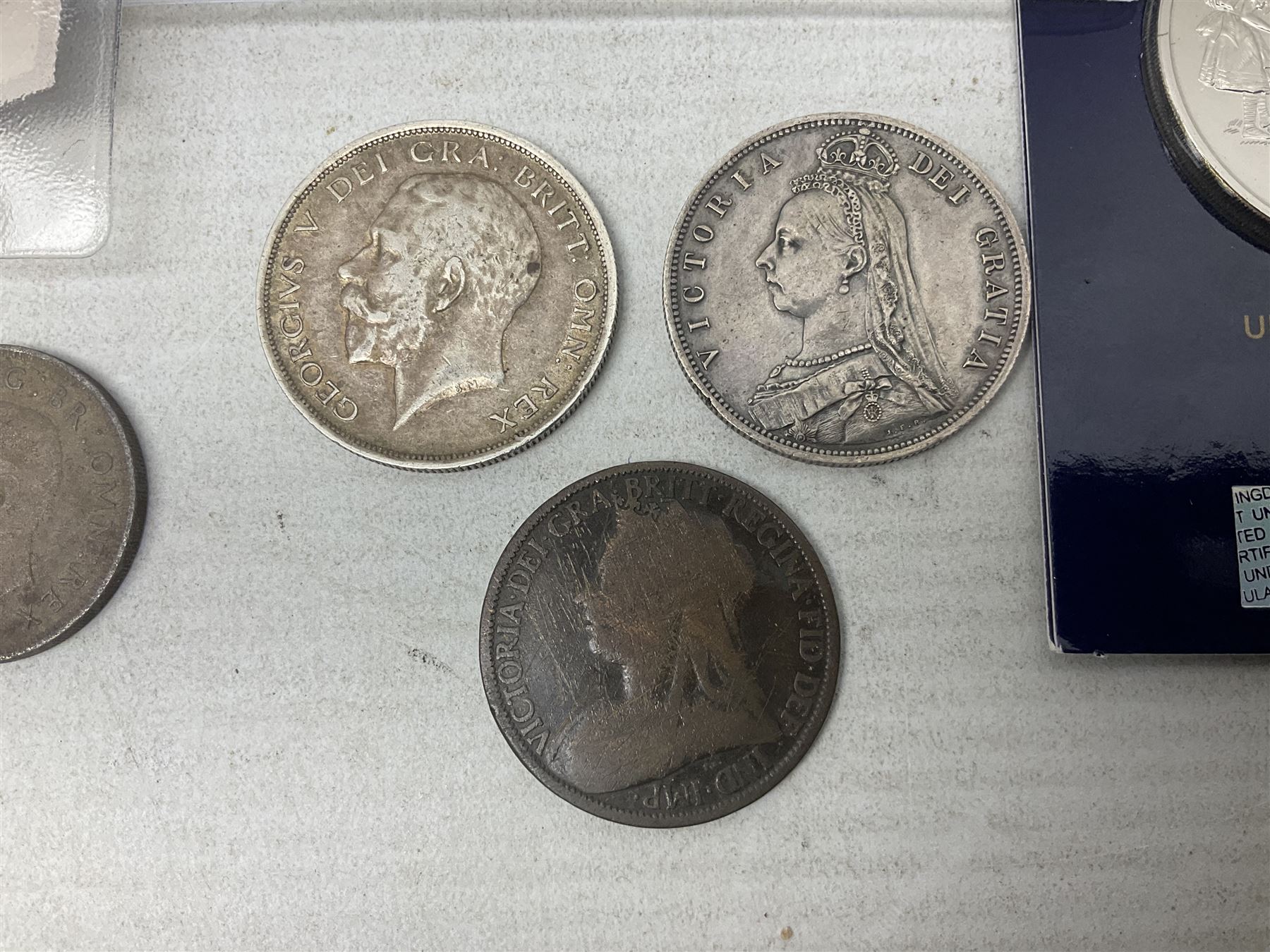 Coins and sets, including Great Britain and Northern Ireland 1970 proof coin collection in card folder, Queen Elizabeth II 2021 'Through the Looking Glass' five pounds, 2021 'Winnie the Pooh' fifty pence, Queen Victoria 1887 halfcrown, King George V 1914 halfcrown, commemorative coins, The Royal Mint Solomon Islands 2003 twenty-five dollars silver proof coin cased with certificate, 9ct gold half sovereign mount etc