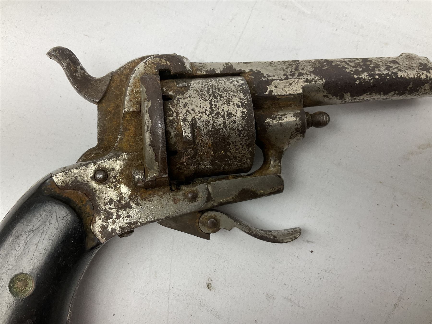 19th century 7mm six-shot pin-fire revolver, with folding trigger, two-piece ebonised grip and ejector rod in butt L17cm