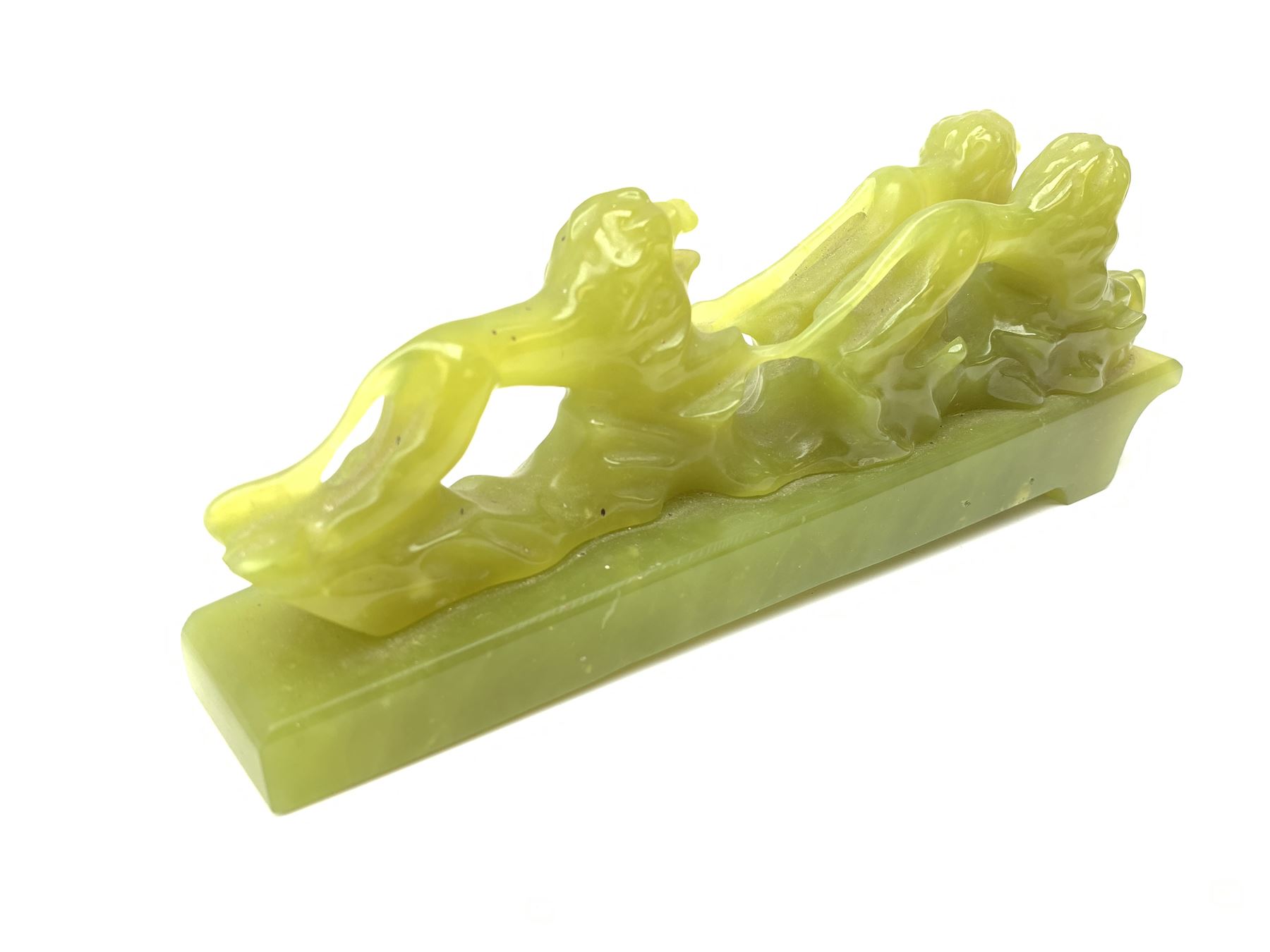Green stone figural group depicting three lions, upon an inclined base, L21cm