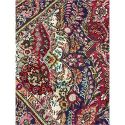 Persian red ground rug, overall floral design with central medallion, trailing foliate border with guards