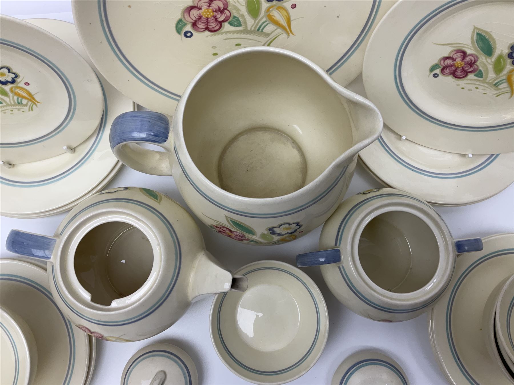 Susie Cooper Nosegay pattern tea service, teapot, eight cups and saucers, six dessert plates, three graduating jugs, covered twin handled sucrier, open sucrier  and cake plate 